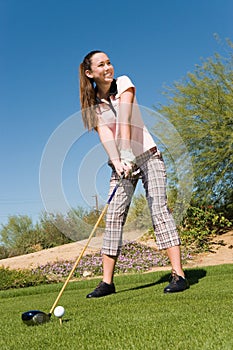 Female Golfer Teeing Off