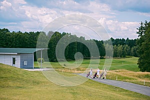 female golfers with golf gear walking at golf course