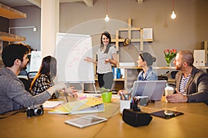 Female graphic designer having discussion with coworkers