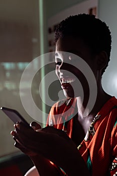 Female graphic designer using mobile phone at desk