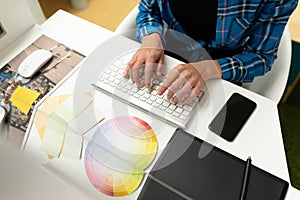 Female graphic designer working on computer at desk