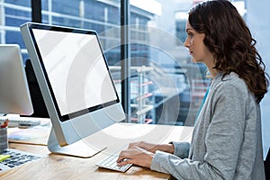 Female graphic designer working over computer at desk