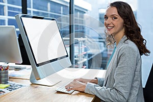 Female graphic designer working over computer at desk