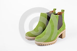 Female green leather elegant shoes on white background.