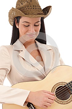 Female guitar player lost in music smiling