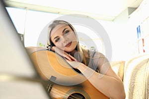 Female Guitar Player Working on Music Composing