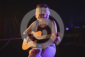 Female guitarist performing in music concert