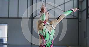 Female gymnast performing at sports hall