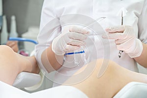 Gynecologist ready to use vaginal speculum instrument to exam patient photo