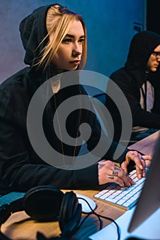 female hacker working on new malware with accomplice