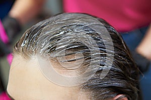 Female hair with applied bleach for hair dye