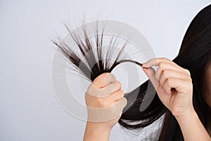 Female hair with split ends on a white background