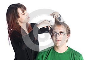 Female hairdresser cutting hair of a male client