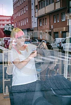 Female hairdresser cutting woman hair in beauty salon