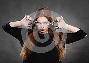 Female hairstylist barber with scissors.