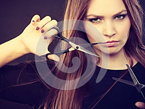 Female hairstylist barber with scissors.