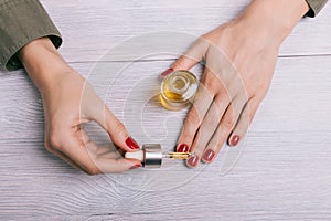 Female hand applied oil on the nails