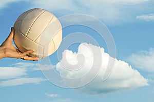 Female hand ball sky clouds