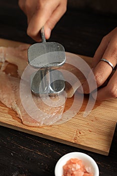 Female Hand Beat Chicken Fillet with Meat Hammer