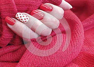 Female hand beautiful  design stylish red manicure decoration sweater elegant