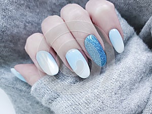 Female hand beautiful fashion blue design stylish ombre acrylic manicure, sweater, winter