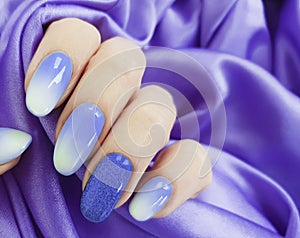 Female hand beautiful manicure, silk fabric