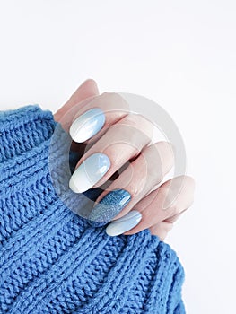 Female hand beautiful manicure, sweater, winter style