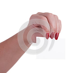 Female hand with beautiful red nails holding a business card