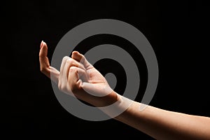 Female hand beckoning isolated on black background