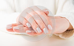 Female hand with beige nail design