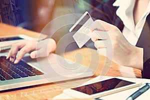 female hand of business woman holding credit card making purchase online