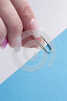 Female hand clipping a paper clip