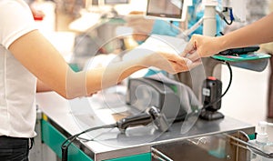 Female hand with coin money pay for goods concept. Hand giving cash and hand receiving cash