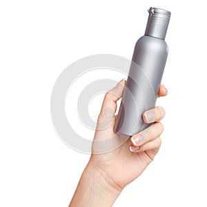 Female hand with a cosmetics bottle