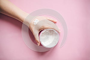 Female hand with cream.