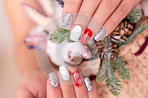 Female hand with creative manicure nails, winter design