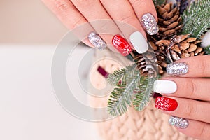 Female hand with creative manicure nails, winter design