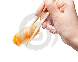 Chopsticks hold sake nigiri sush with salmon photo