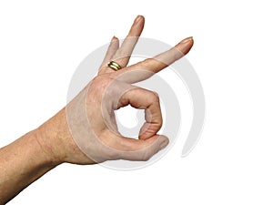 Female hand with double gold wedding ring making OK sign