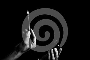 female hand elegantly holding an ink pen with a metal tip close-up on a black background. classic fountain pen isolated