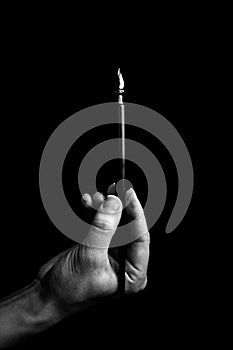 Female hand elegantly holding an ink pen with a metal tip close-up on a black background. classic fountain pen isolated macro