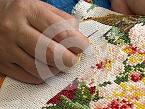 Female hand embroider at cross