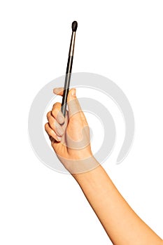 Female hand with eyeshadow or concealer brush