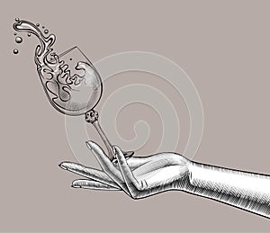 Female hand with a falling glass with splashed wine