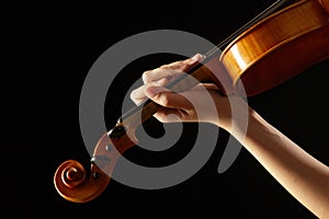 Female hand on the fingerboard violin