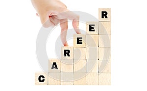 Female hand fingers climbing the stairs made of wooden blocks spelling the word CAREER isolated on white.