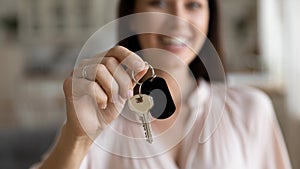 Female hand first home owner holding house key, closeup view
