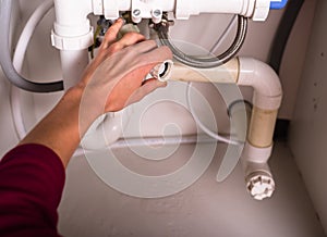 Female hand fixing plumbing