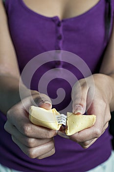 Female hand and fortune cookie