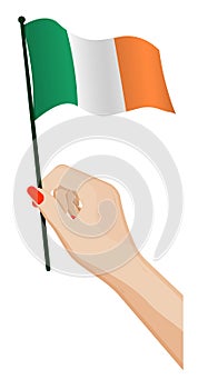 Female hand gently holds small irish flag. Holiday design element. Cartoon vector on white background